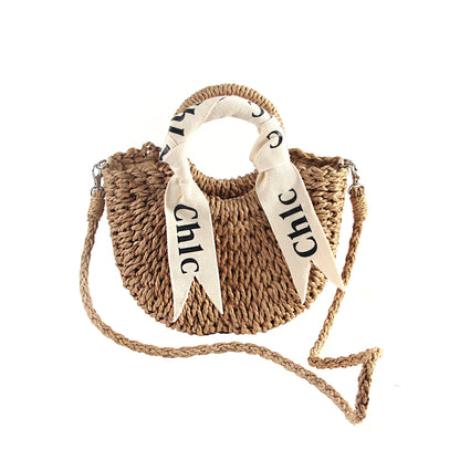 Brown woven straw shoulder handbag with drawstring, front view