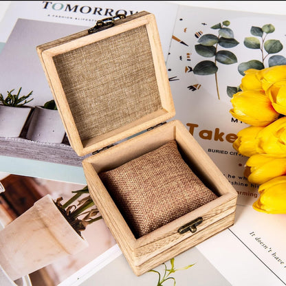 Inside view of wooden jewelry box with watch pillow