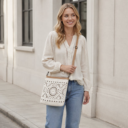 Off White Crochet Shoulder Bag worn on the shoulder in a street setting, showing its cotton crochet texture and boho everyday style