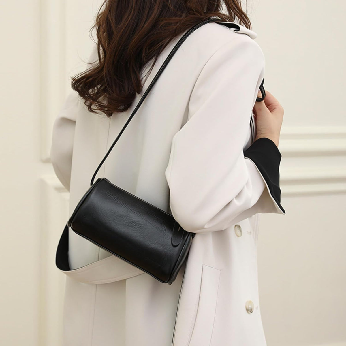 Black Leather Crossbody Bag styled for shoulder wear with an adjustable strap and sleek minimalist silhouette