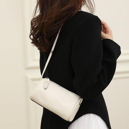 White Leather Crossbody Bag worn for a street look with a graceful shape and versatile styling appeal