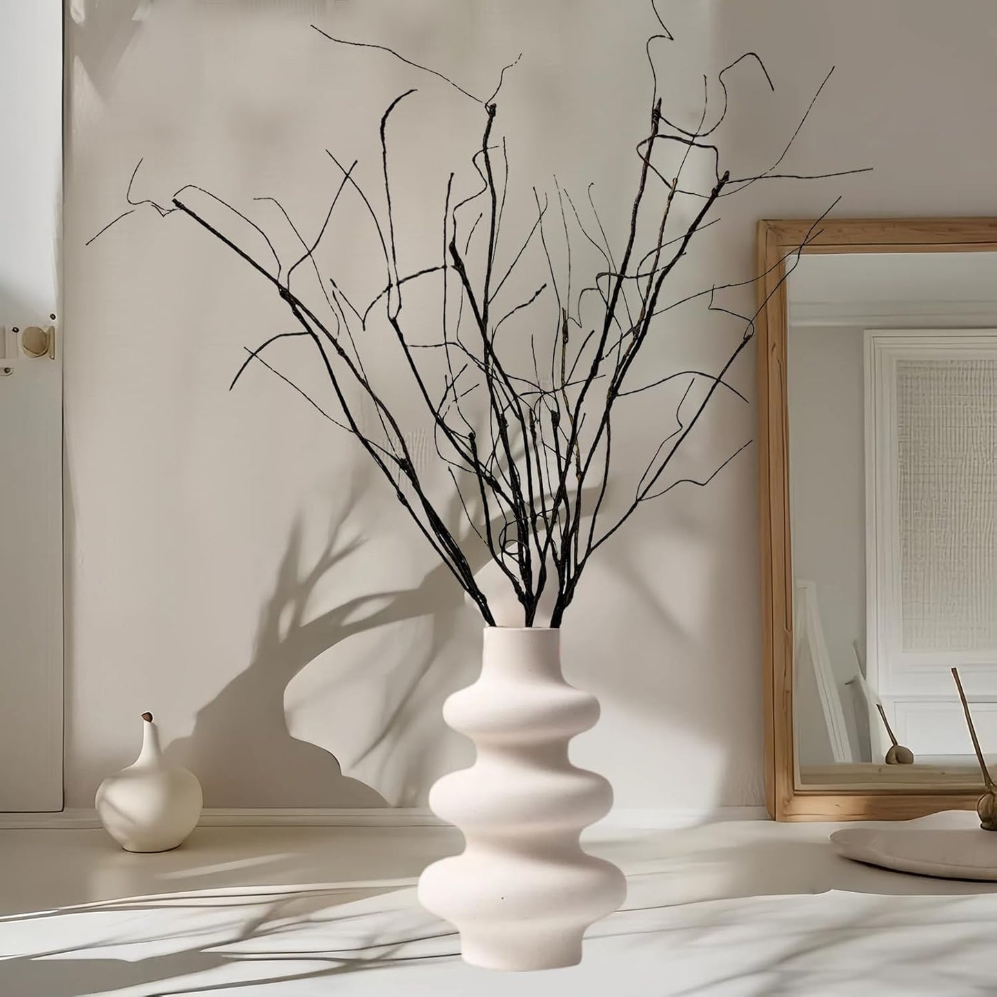 Bendable artificial curly willow branches styled in a tall glass vase for modern home decor